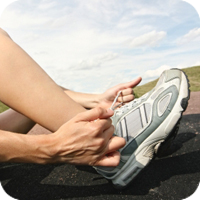 image of person putting on a shoe.