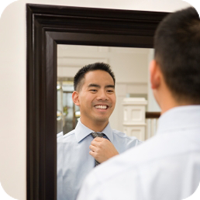 Image of man looking at himself in mirror.