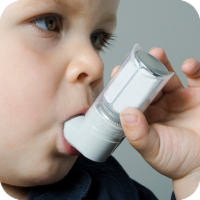 image of young boy using an inhaler