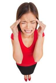 image of grimacing woman holding her temples