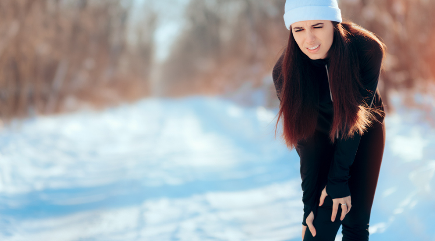 Woman in pain in the snow